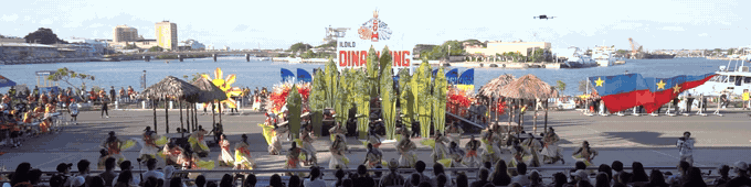 Cry of Jelicuon performers raising tall props upright during the performance