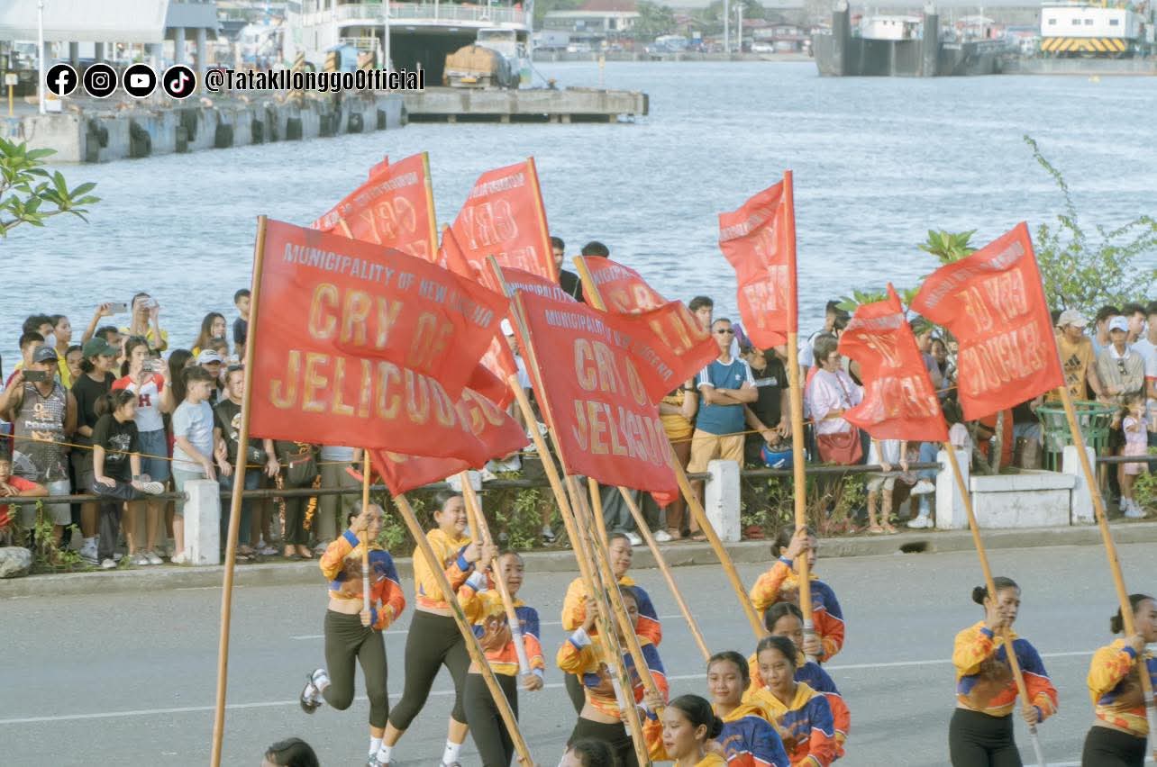 Cry of Jelicuon contingent marching the parade route with banners