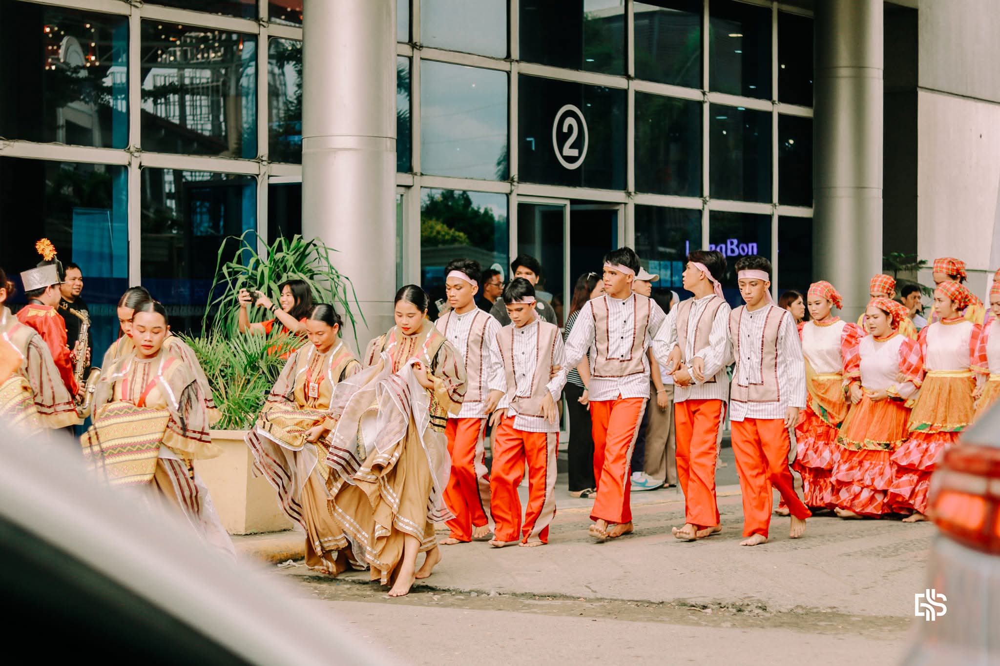 Cry of Jelicuon performers moving together in a procession line through the street