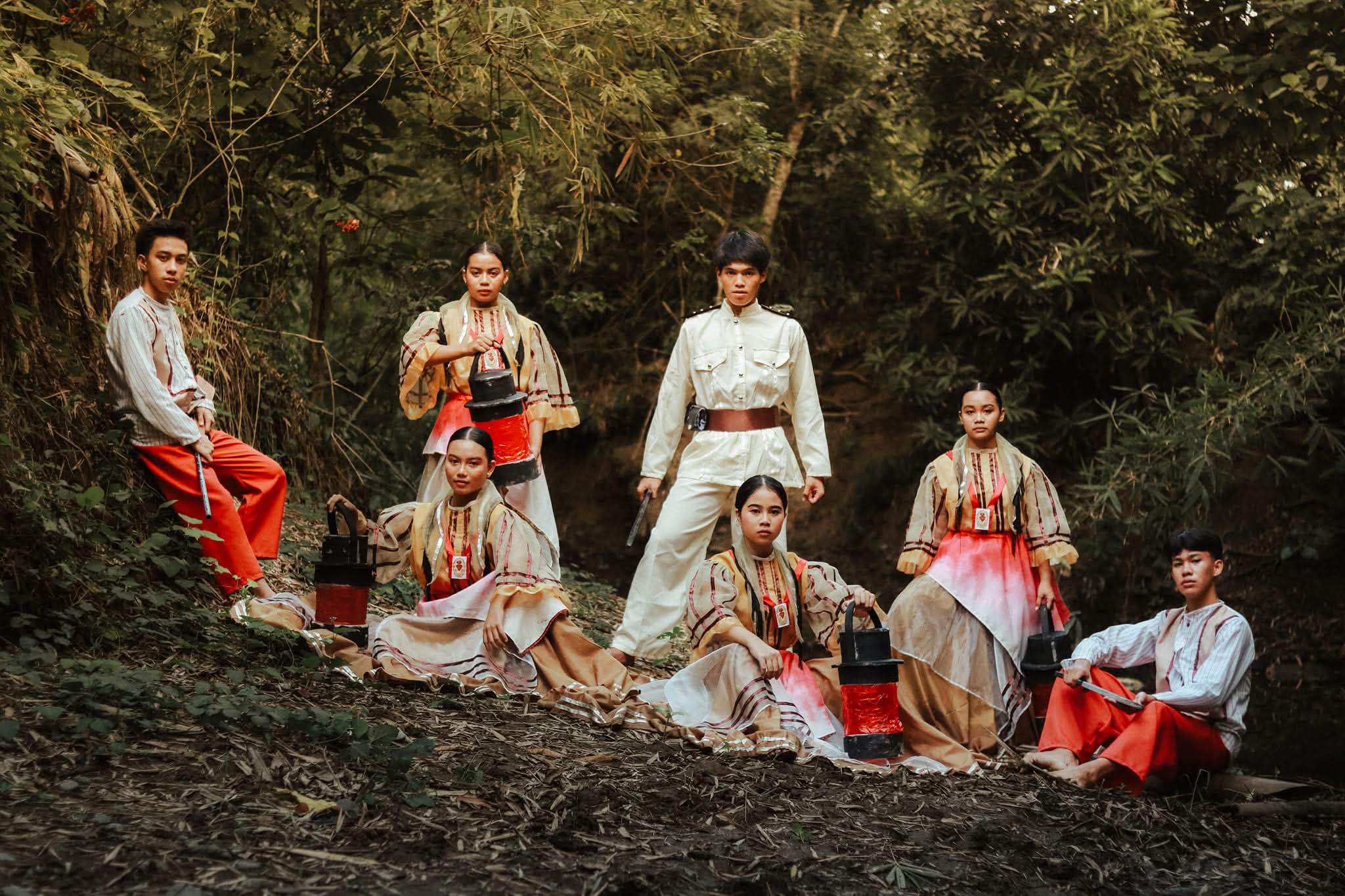 Cry of Jelicuon reenactment troupe resting in the forest after a performance, holding lanterns