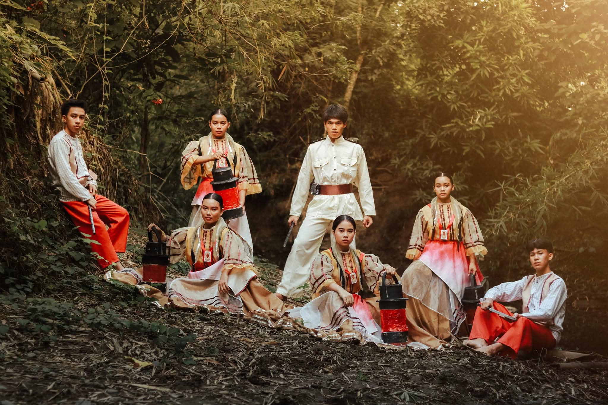Cry of Jelicuon troupe at dusk holding raised lanterns, still and at rest