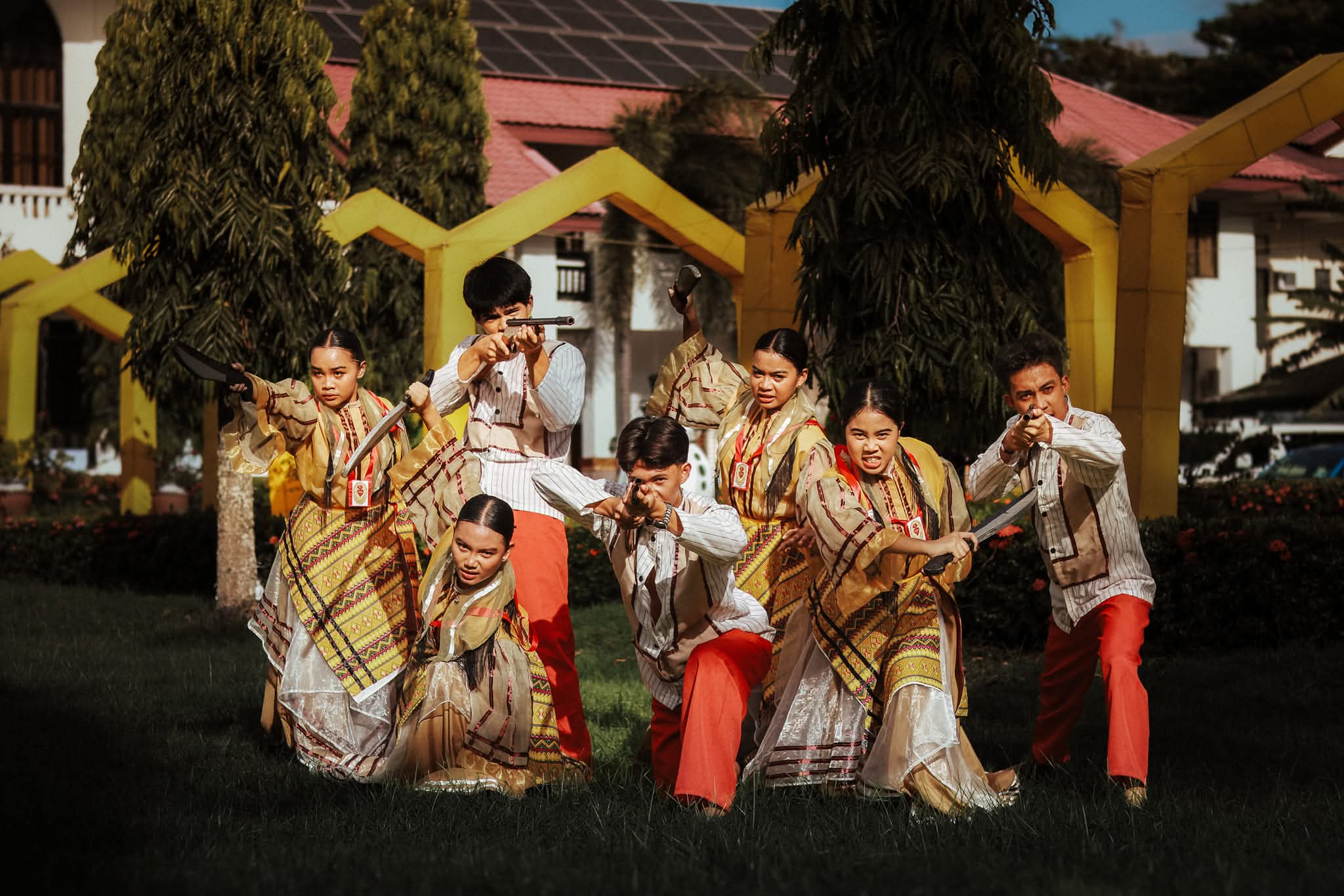 Cry of Jelicuon performers lunging into a dramatic war-scene charge